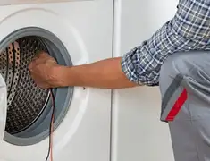 Dryer repair technician diagnosing and servicing a clothes dryer in Worcester, MA