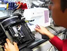 Vacuum repair technician servicing internal components on a workbench in Worcester, MA