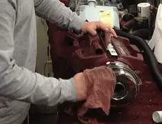 Vacuum repair technician cleaning and servicing a vacuum motor in Worcester, MA